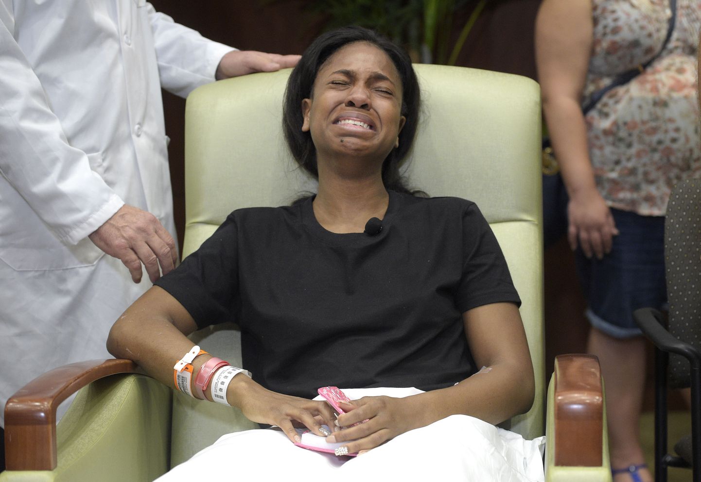 Patience Carter, a victim in the Pulse nightclub shooting from Philadelphia, becomes emotional after giving her story during a news conference at Florida Hospital Orlando, Tuesday, June 14, 2016, in Orlando, Fla. Carter, a 20-year-old Philadelphian, was visiting Florida for the first time, vacationing with her two friends. (AP Photo/Phelan M. Ebenhack)