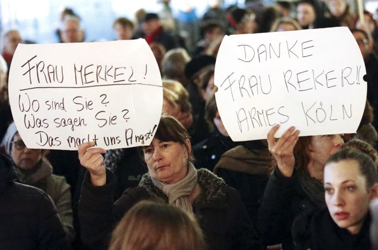 Надписи на плакатах: «Госпожа Меркель! Где вы? Что вы говорите? Это нас беспокоит!» и «Спасибо, госпожа Рекер (мэр Кельна)! Бедный Кельн». Фото: Reuters/Scanpix
