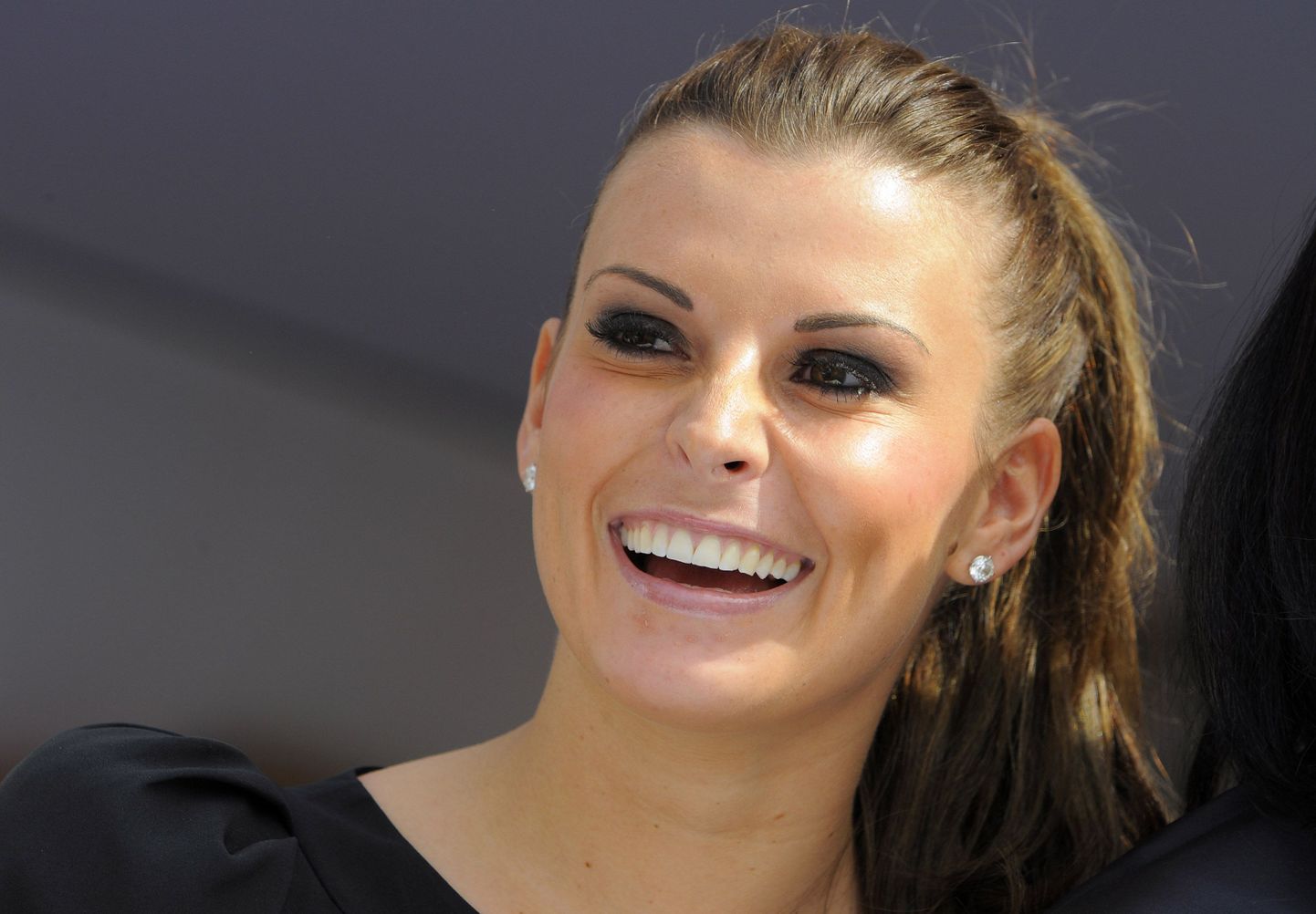 Coleen Rooney, wife of Manchester United's Wayne Rooney, watches during the second day of The Grand National Meeting at Aintree Racecourse in Liverpool April 9, 2010. REUTERS/Nigel Roddis (BRITAIN - Tags: SPORT HORSE RACING SOCCER FASHION)