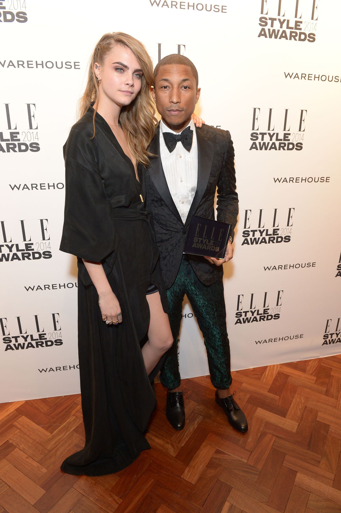 British model Cara Delevingne, left, poses for photographers with winner of the International Recording Artist of the Year award Pharrell Williams at the ELLE Style Awards 2014 held at One Embankment on Tuesday Feb. 18, 2014, in London. (photos by Jon Furniss/Invision/AP) / TT / kod 436