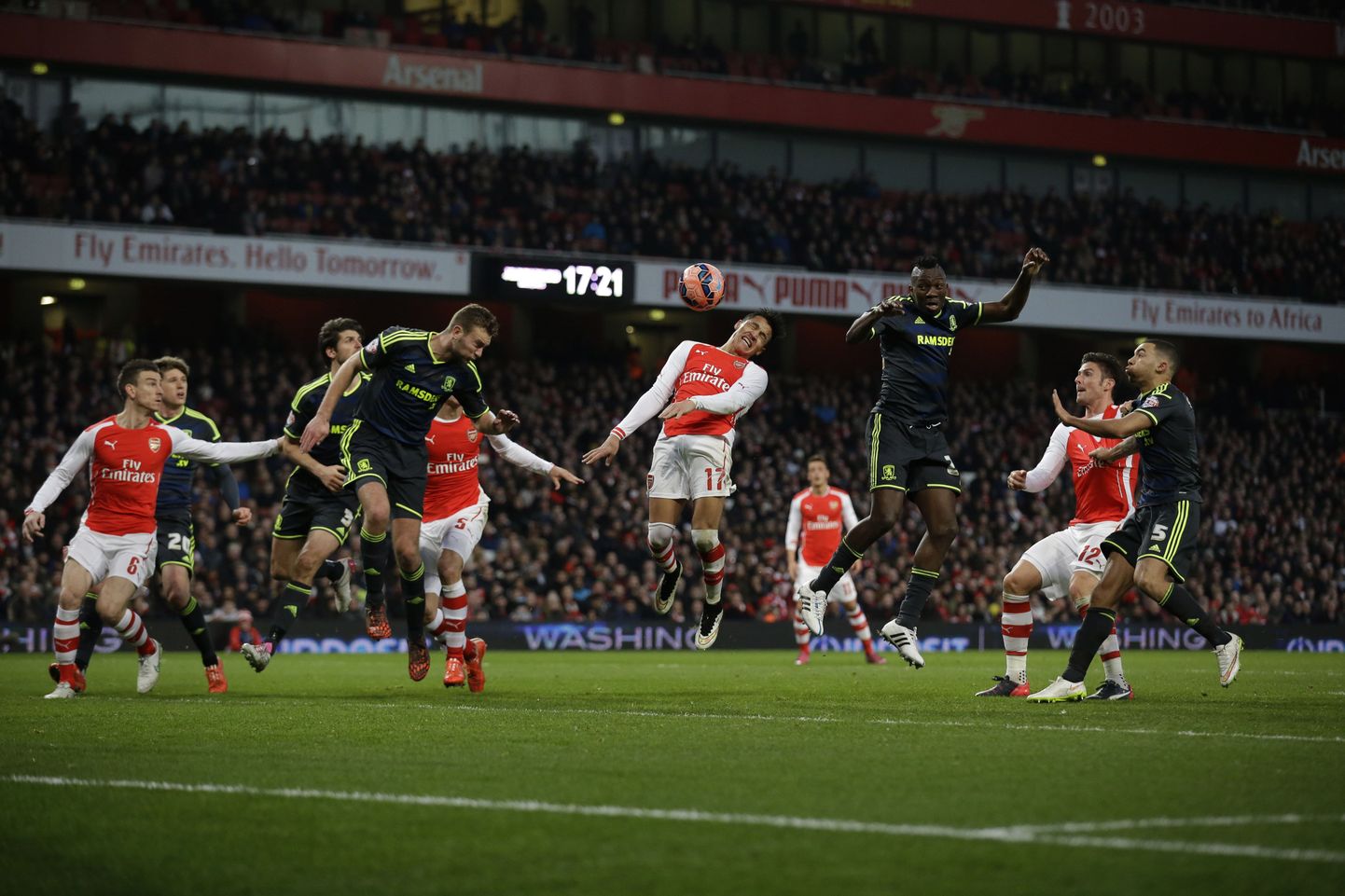 Arsenal's Alexis Sanchez, center, makes a failed attempt to score, during the English FA Cup fifth round soccer match between Arsenal and Middlesbrough at the Emirates Stadium in London, Sunday, Feb. 15, 2015.  (AP Photo/Matt Dunham)