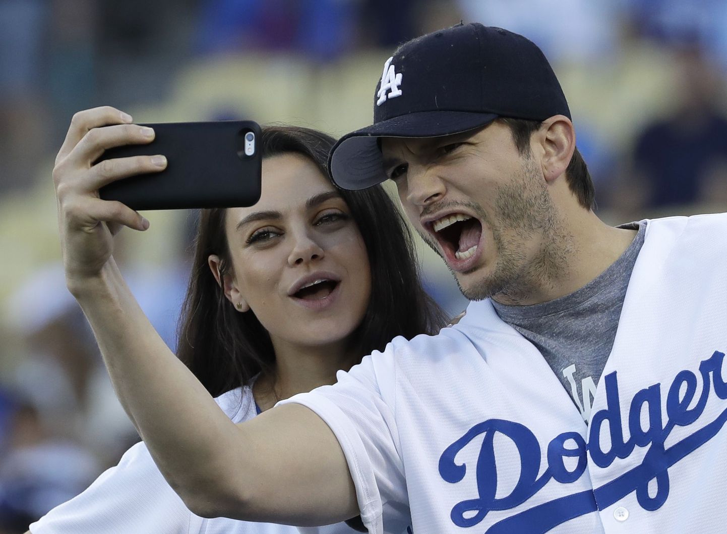 FILE- In this Oct. 19, 2016, file photo, Ashton Kutcher and wife Mila Kunis take a selfie before Game 4 of the National League baseball championship series between the Chicago Cubs and the Los Angeles Dodgers in Los Angeles. Kunis and Kutcher are parents for the second time. A publicist for the actress said in an email Thursday, Dec. 1, that Kunis had given birth. (AP Photo/David J. Phillip, File)