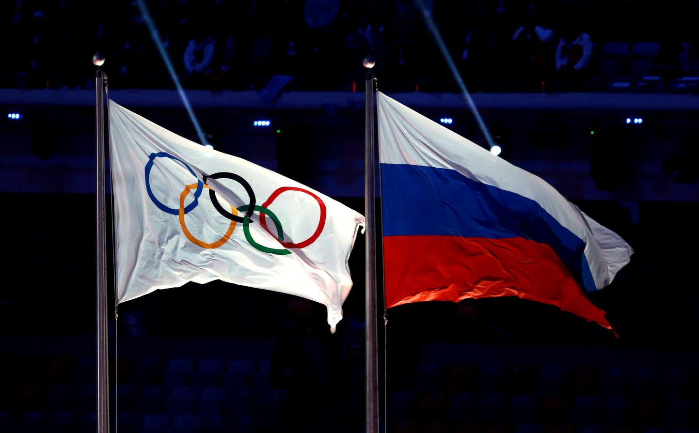 Олимпийский флаг и флаг России.