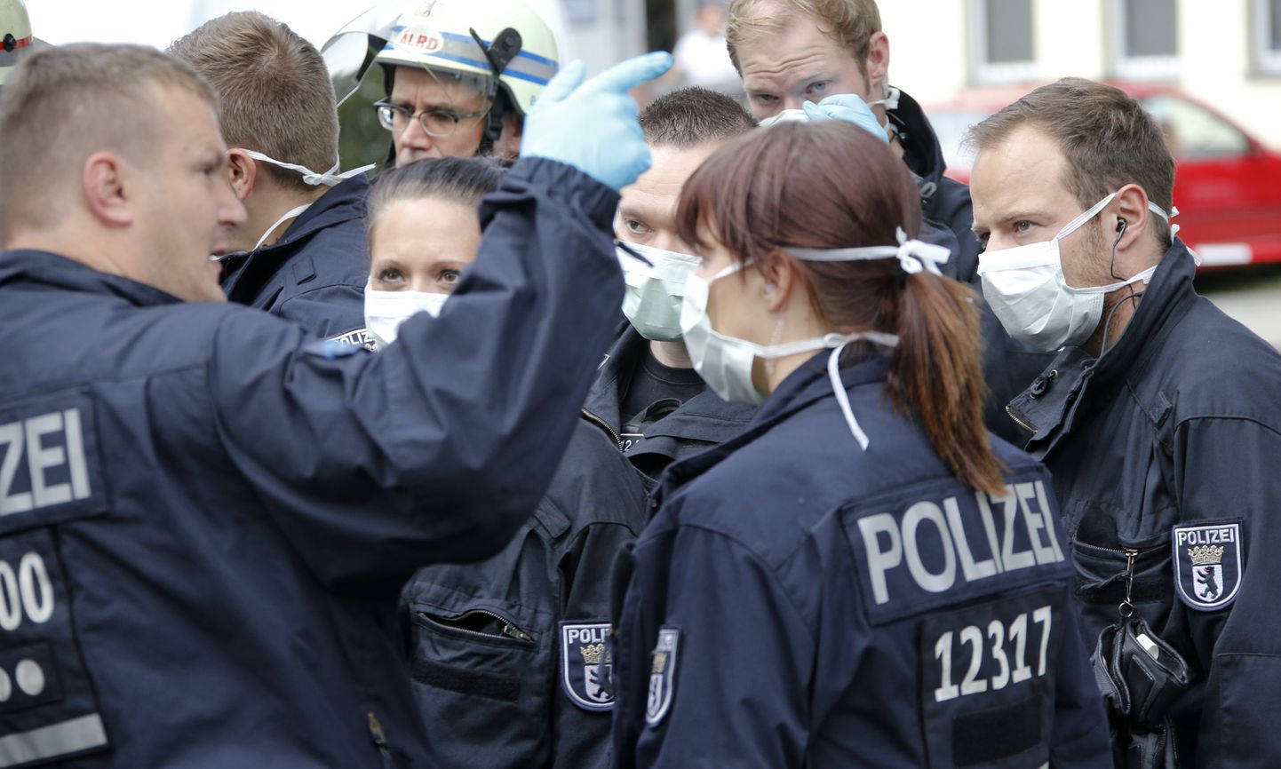 Kaitsemaskidega politseinikud täna Berliinis, kus ühel naisterahval kahtlustati Ebola sümptomeid.
