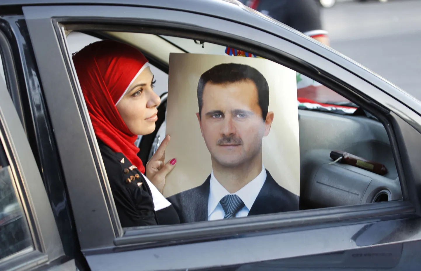 Süüria režiimi toetaja eile Damaskuses, käes samal päeval oma 48-aastast sünnipäeva tähistanud Bashar al-Assadi pilt.