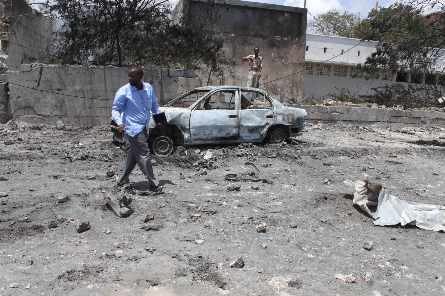 Kohalik mees ja autovrakk Muqdishos pärast pommirünnakut.