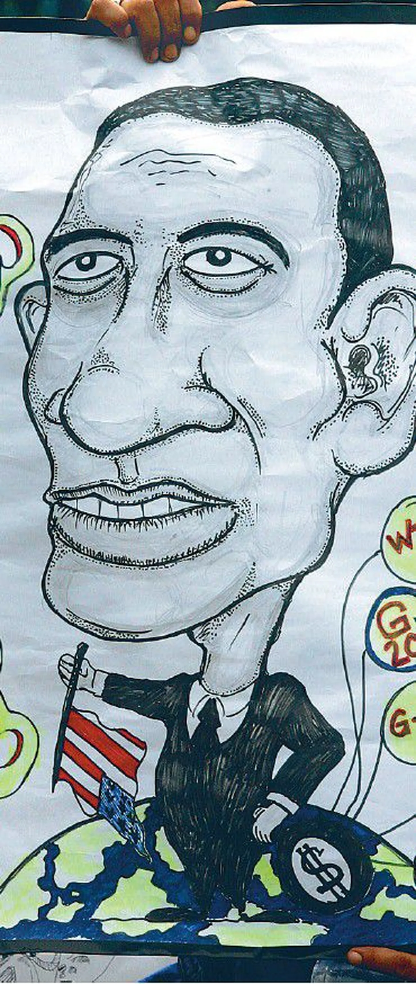 Barack Obamast oodatakse maailmas juba praegu palju. Meeleavaldaja hoidmas
Obamat kujutavat karikatuuri maailma juhtivate riikide G-20 kohtumisel Indoneesiasn Jakartas.