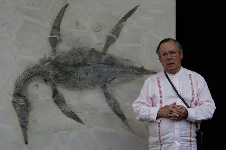 Mauricio Fernandez peab oma kodus pressikonverentsi. Tema kõrval on hästi säilinud fossiil, mille nimeks pandi «Mauriciosaurus Fernandezi».