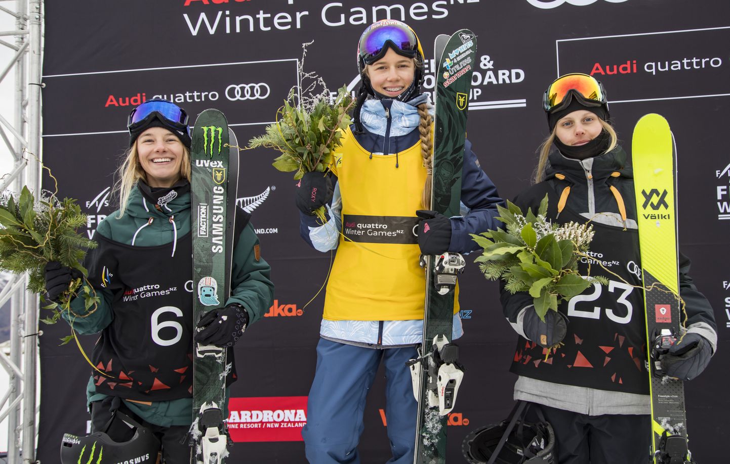 Winter Games New Zealand women's ski slopestyle final winner Kelly Sildaru of Estonia, centre, stands with second placed Jennie-Lee Burmansson of Sweden, left, and third placed Giulia Tanto of Switzerland on the podium during the flower ceremony at Cardrona ski resort in Queenstown, Sunday, Aug. 27, 2017. (Neil Kerr/Winter Games NZ via AP)