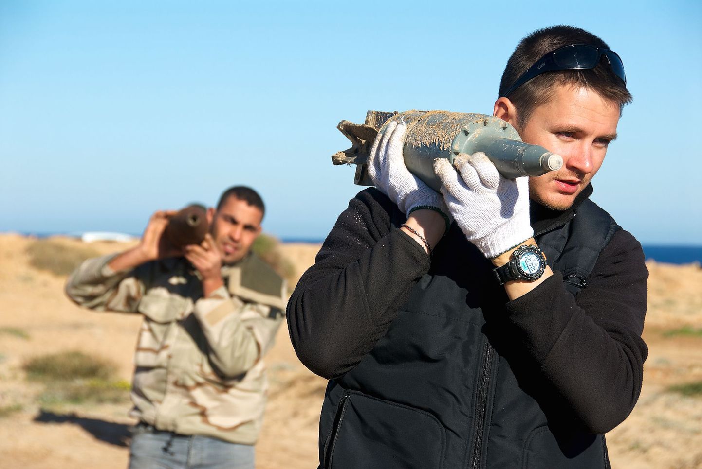 Опасная работа: Кайдо Кеэрдо (на переднем плане) помогает очищать Ливию от неразорвавшихся снарядов. Этот снимок был сделан всего за пару недель до гибели эстонского сапера.