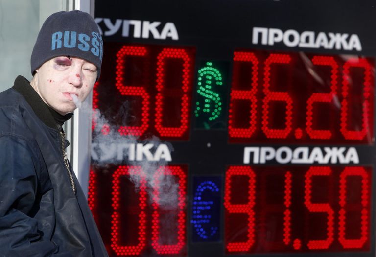 Suitsu tegev noormees möödumas Moskvas valuutavahetuspunkti kursitabloost.