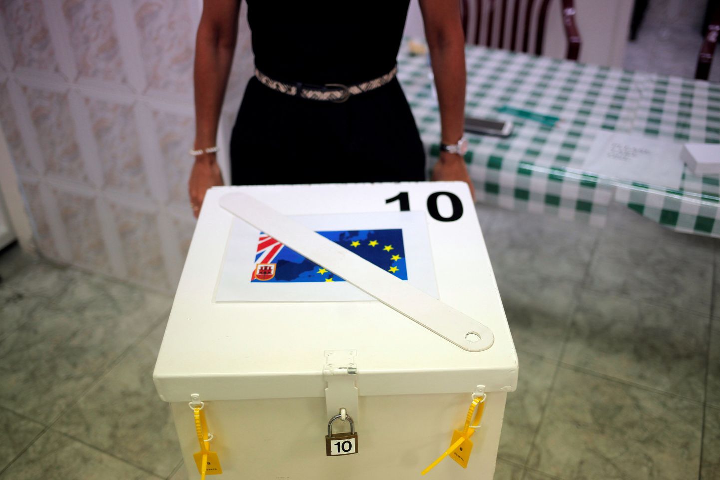 A member of a polling station stands next to a polling box as she waits for citizens during the EU referendum in the British overseas territory of Gibraltar, historically claimed by Spain, June 23, 2016. REUTERS/Jon Nazca