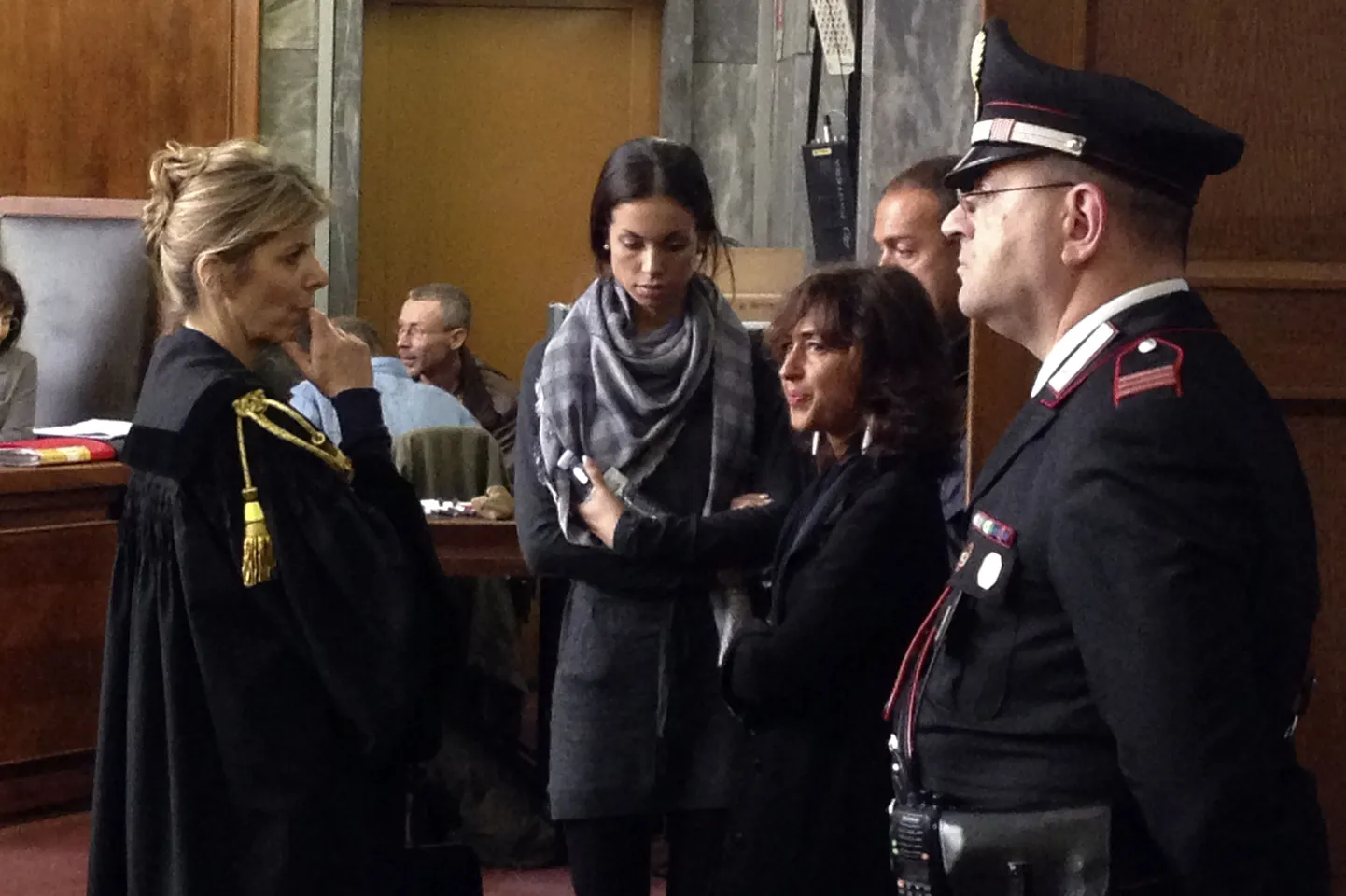 TALY, Milan : This picture taken with a smartphone shows Moroccan-born Karima El-Mahroug, nicknamed "Ruby the Heart Stealer" (C), during a pause of a session of former Prime Minister Silvio Berlusconi's trial for having sex with an underage prostitute and abuse of office on May 17, 2013 at Milan's tribunal.The hearing is one of the last in a trial that began two years ago and relates to alleged crimes in 2010 when Berlusconi was still prime minister and revolves around alleged raunchy "bunga bunga" parties at his luxury residence outside Milan. AFP PHOTO / OLIVIER MORIN