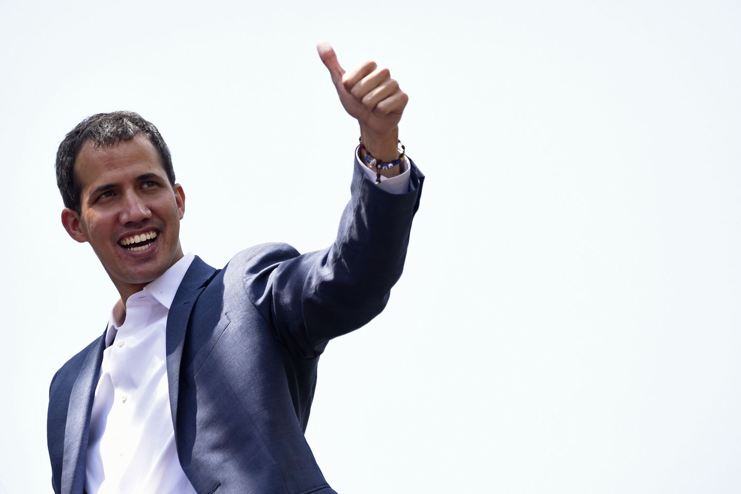 TOPSHOT - Opposition leader Juan Guaido gives his thumb up to thousands of supporters, in Caracas on February 2, 2019. - Tens of thousands of protesters were set to pour onto the streets of Caracas to back self-proclaimed acting president Guaido's calls for early elections as international pressure increased on President Nicolas Maduro to step down. Major European countries have set a Sunday deadline for Maduro to call snap presidential elections. (Photo by Juan BARRETO / AFP)