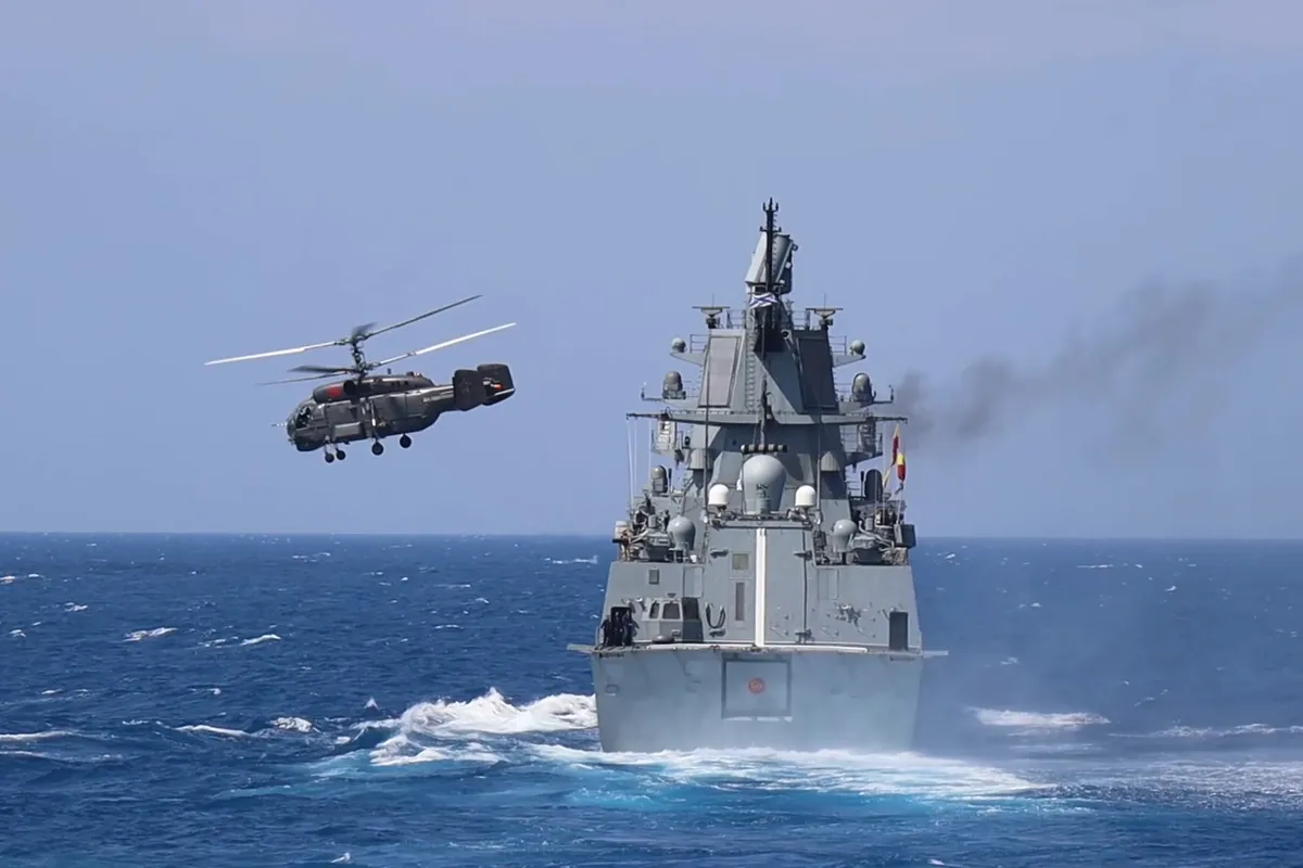 Russian frigate Admiral Grigorovich sails while the Kamov Ka-27 helicopter takes off from its flight deck during the Ocean-2024 strategic command and staff exercises in the Mediterranean Sea off the coast of Tartus, Syria.