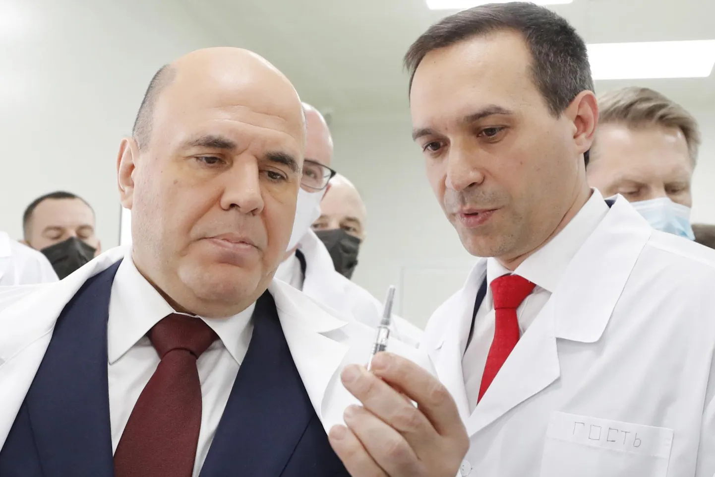 Vene peaminister Mihhail Mišustin märtsis Novosibirskis EpiVacCoronaga täidetud süstalt vaatamas.