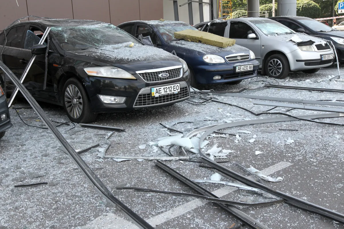 JULY 3, 2024 - Damaged cars are pictured outside a shopping mall affected by the Russian missile strike in Dnipro, east-central Ukraine, on Wednesday morning. At least five people was killed and 34 people injured in the attack.