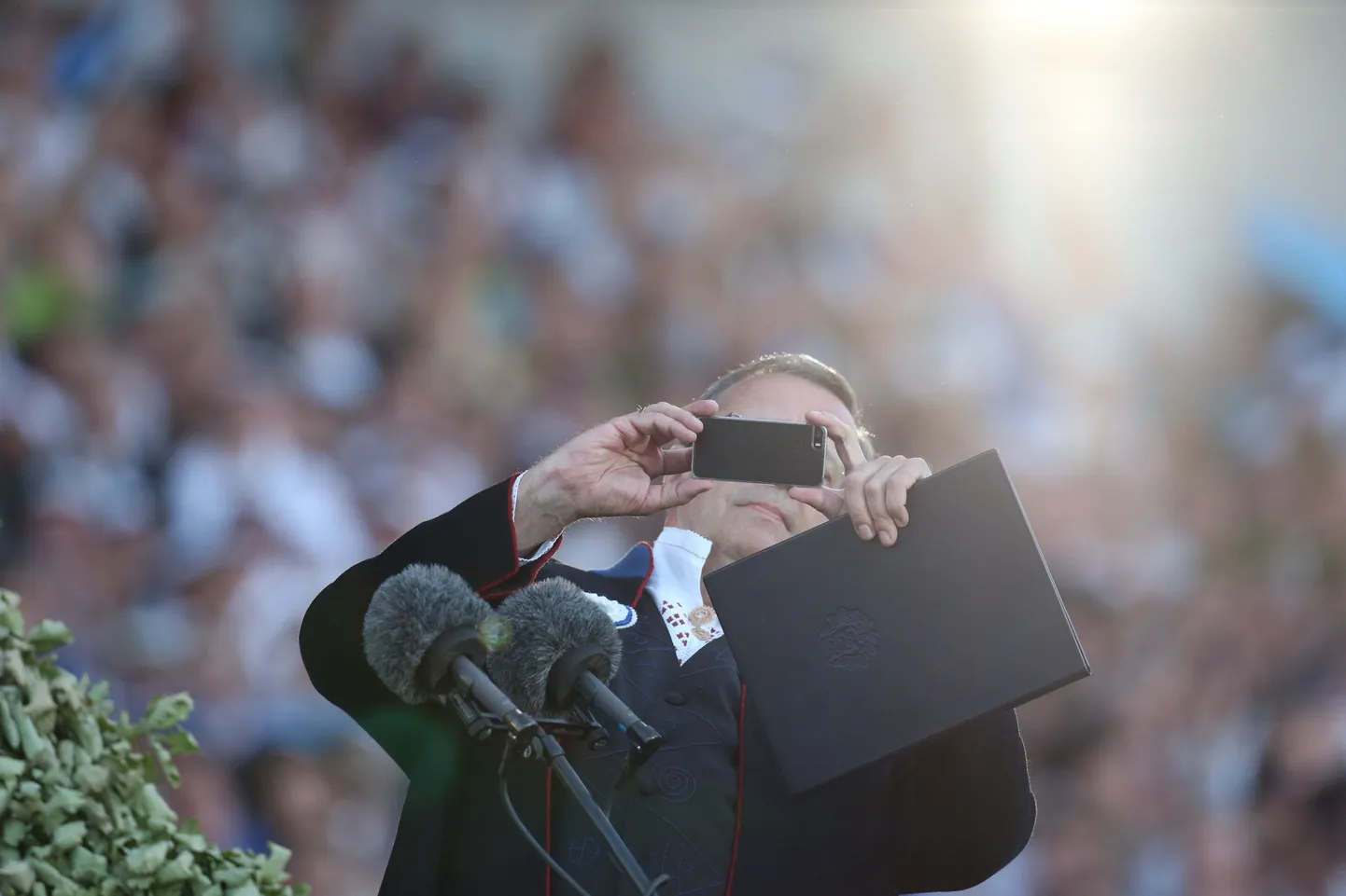 President mobiiltelefoniga laulupeol selfie't tegemas.