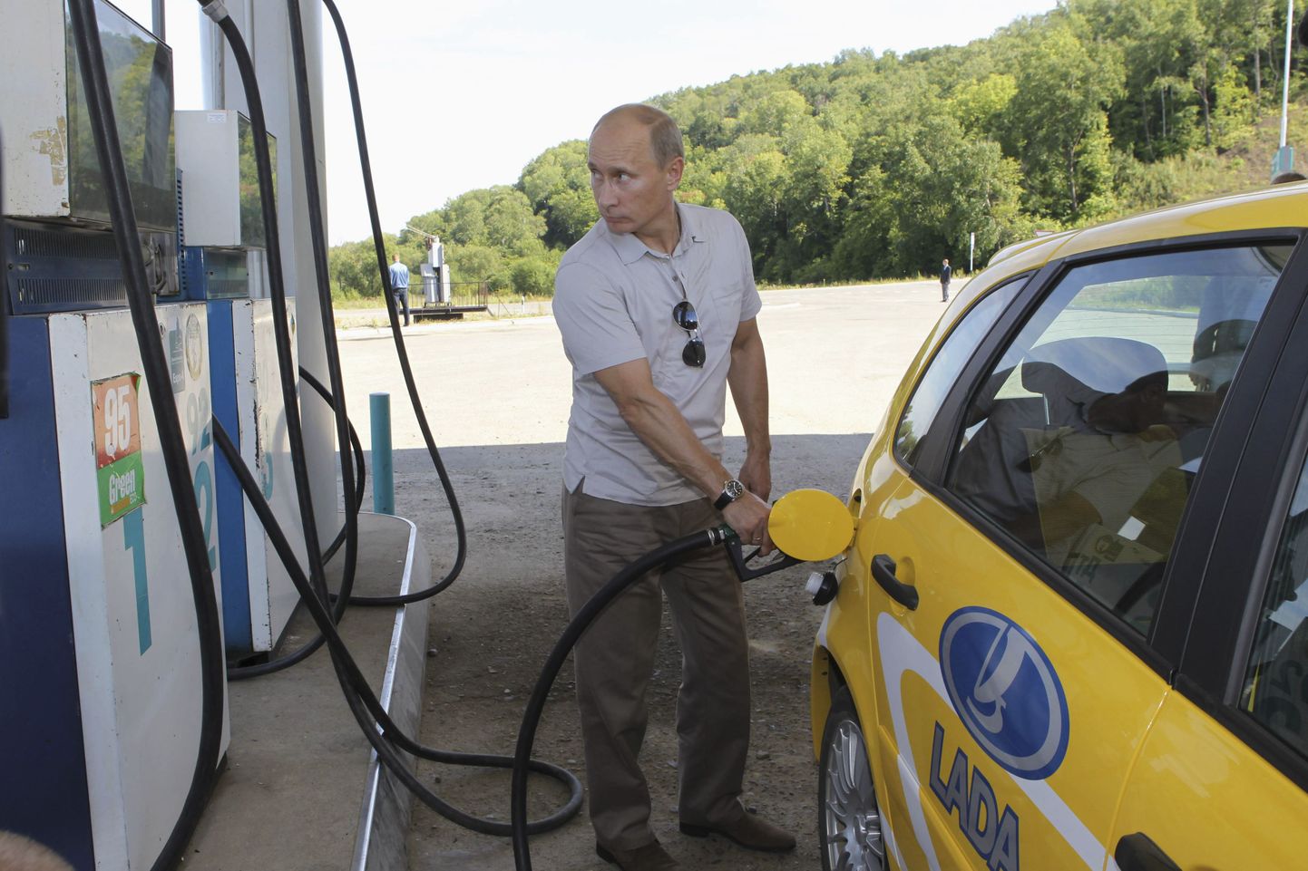 Владимир Путин заправляет новый автомобиль Lada Kalina в Хабаровской области.
