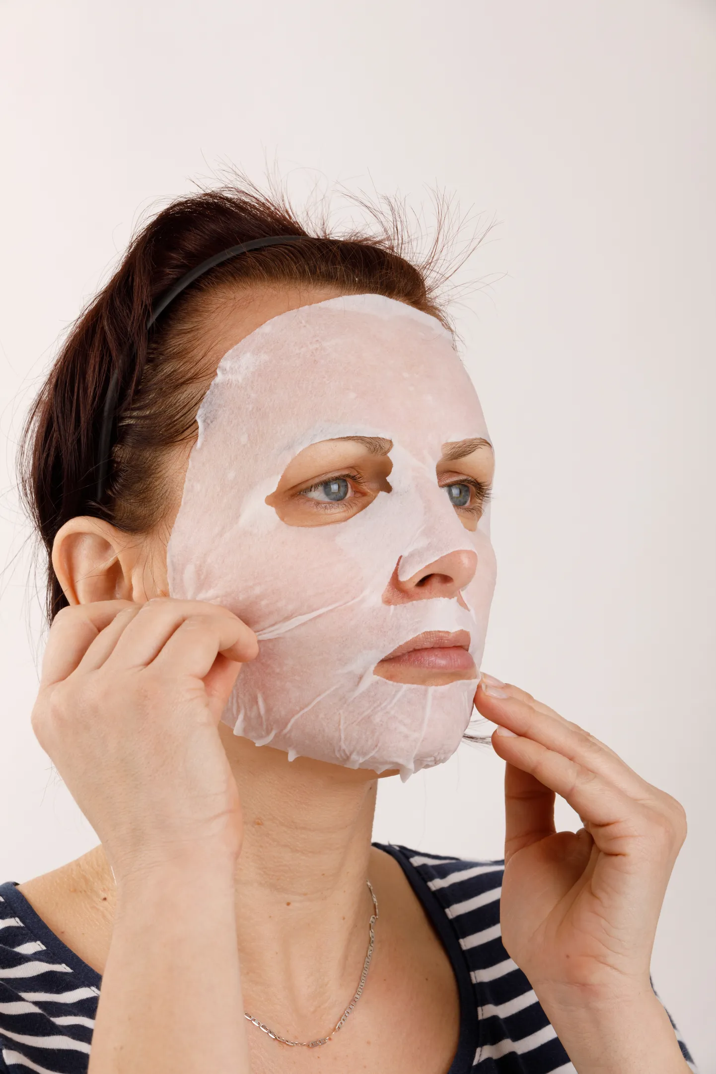 housewife woman with a sheet mask on her face