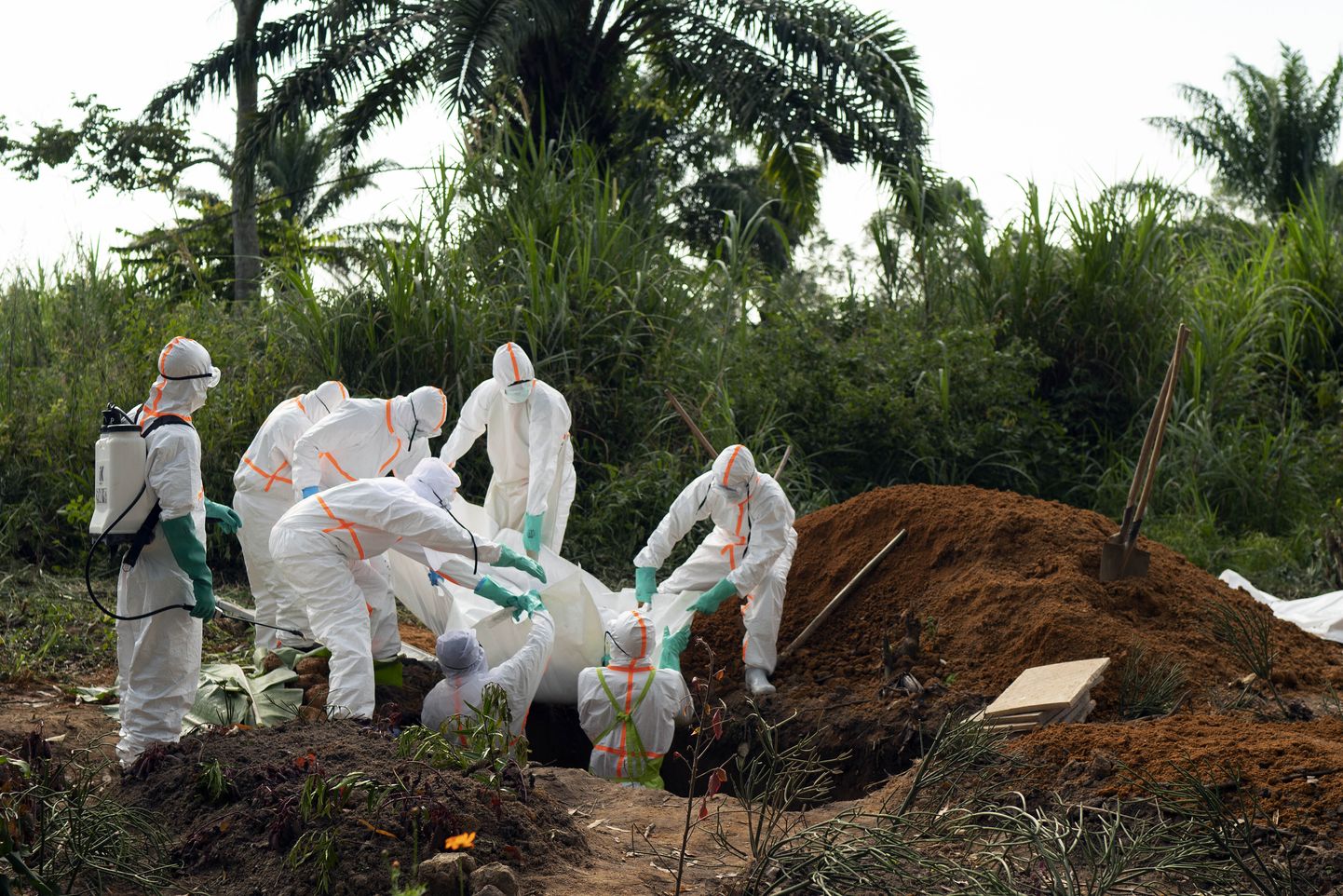 Жертв Эболы хоронят в земле.