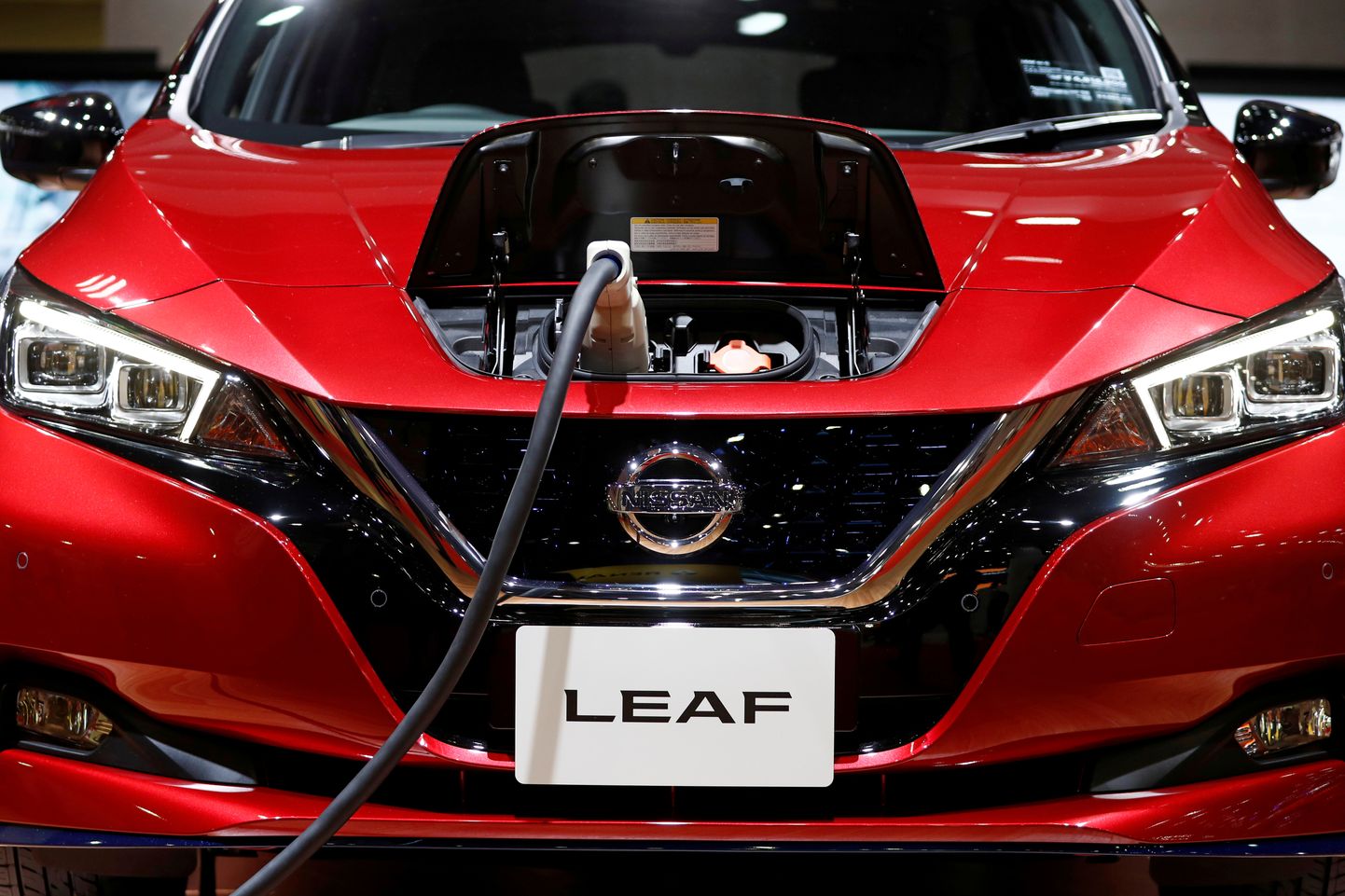 FILE PHOTO: A charging cable is attached to a Nissan Leaf electric car at the Tokyo Motor Show, in Tokyo, Japan October 24, 2019. REUTERS/Edgar Su/File Photo  GLOBAL BUSINESS WEEK AHEAD