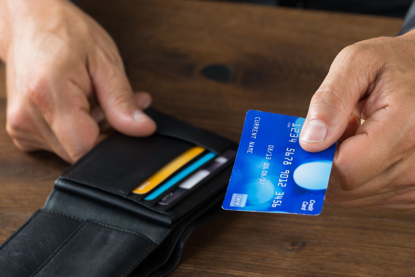Businessman Giving Credit Card From Wallet