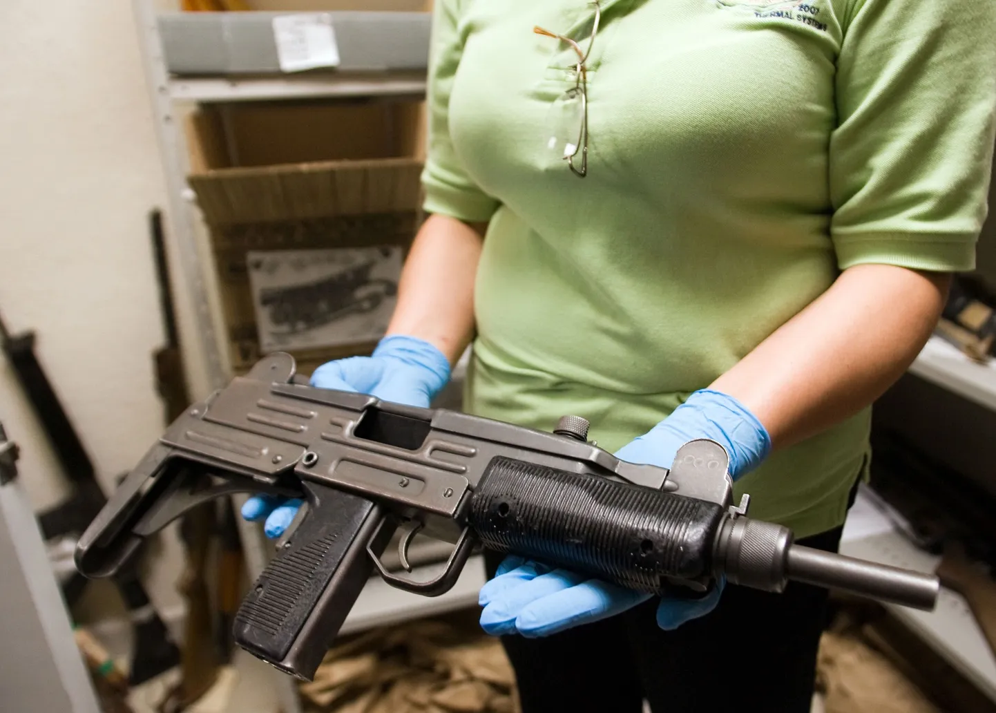 Uzi püstolkuulipilduja kriminoloogi kätel.