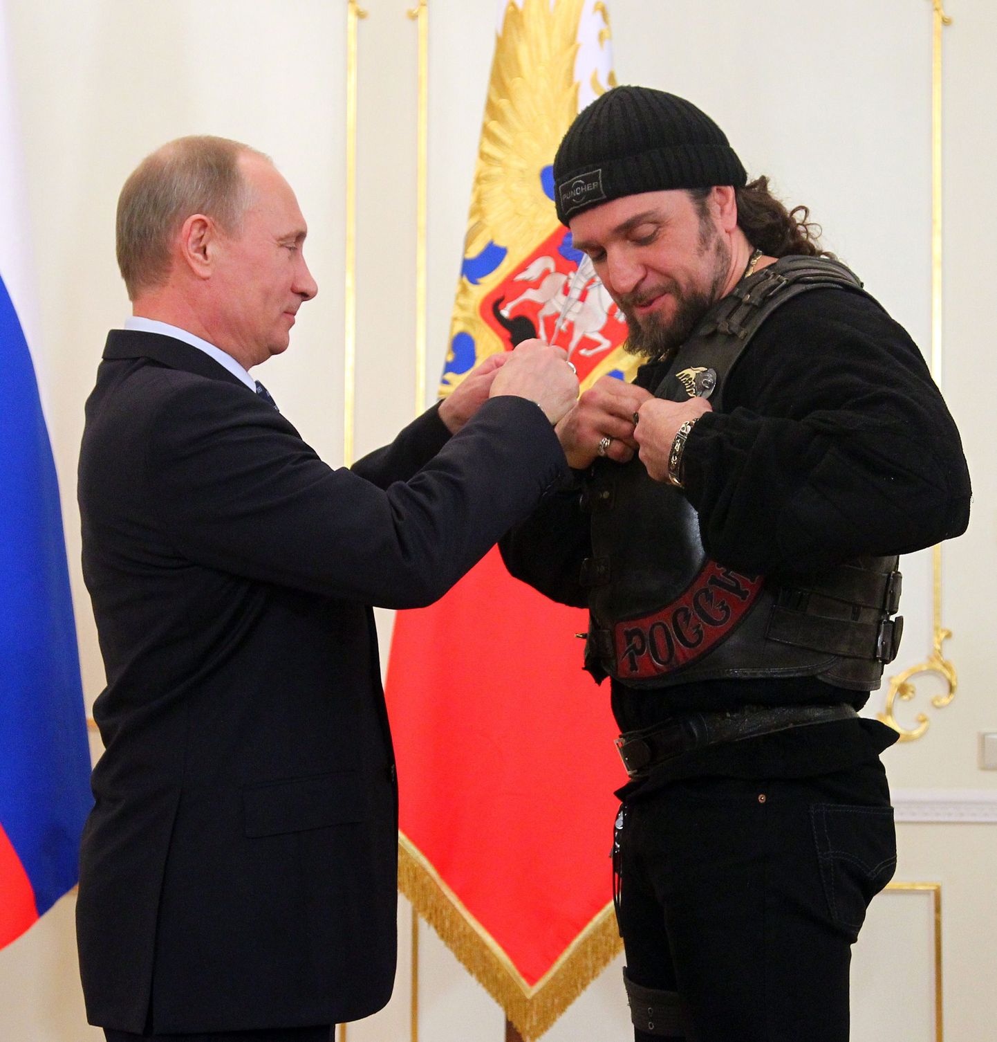Russian President Vladimir Putin, left, presents a medal to Alexander Zaldostanov, a leader of Russian bikers movement, at his meeting with members of the Military History Society in the Novo-Ogaryovo residence outside Moscow, Thursday, March 14, 2013. (AP Photo/RIA-Novosti, Mikhail Klimentyev, Presidential Press Service) / SCANPIX Code: 436
