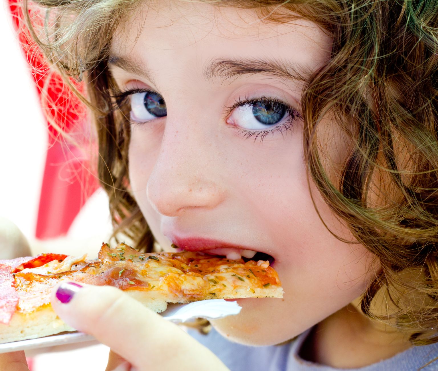 blue eyes child girl eating pizza slice