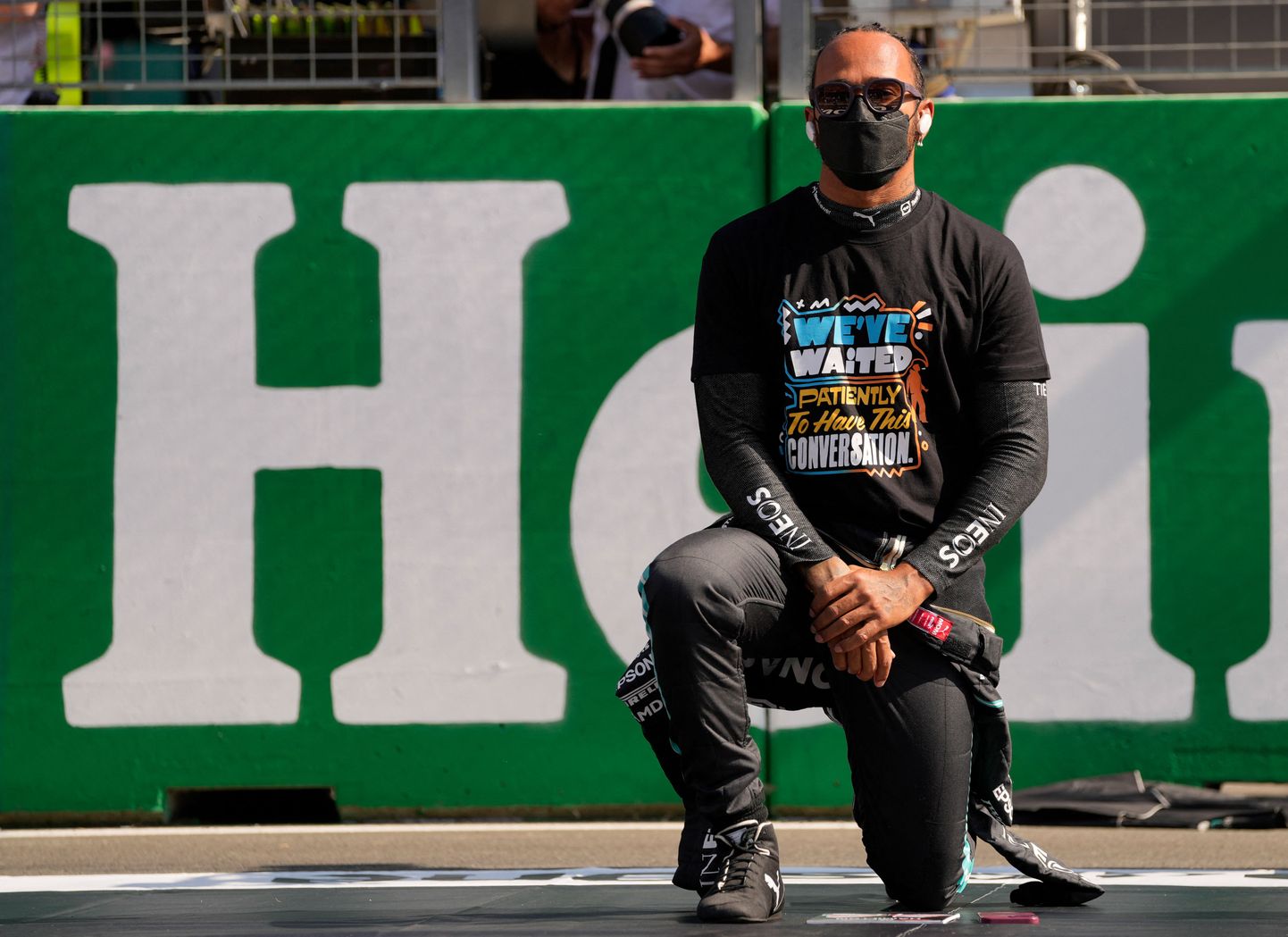 Mercedes' British driver Lewis Hamilton kneels down during F1's 'We Race As One' anti-racism campaign on the grid of the Zandvoort circuit before the start of the Netherlands' Formula One Grand Prix in Zandvoort on September 5, 2021. (Photo by Francisco Seco / POOL / AFP)