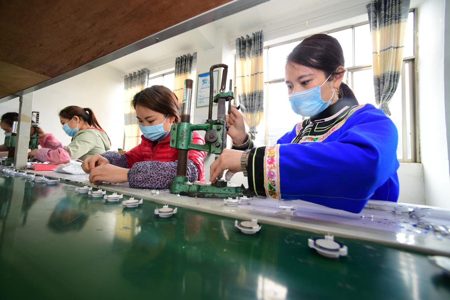Elektroonikaettevõtte töötajad Hiinas Rongjiangi maakonnas, mis on keerukast olukorrast väljatulemiseks toonud olemasolevale 190 000 töötajale lisaks mujalt sisse 140 000 töölist.