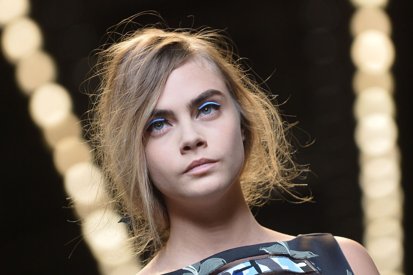British model Cara Delevingne presents a creation of the Fendi collection during the 2015 Spring / Summer Milan Fashion Week on September 18, 2014 in Milan.  AFP PHOTO / TIZIANA FABI