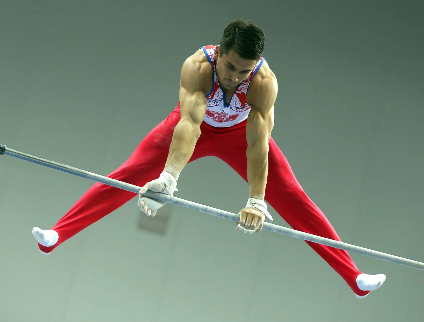 ITAR-TASS: KAZAN, RUSSIA. JULY 9, 2013. Russia's Nikolai Kuksenkov performs on a horizontal bar to win the men's artistic individual all-around at the 27th Summer Universiade. (Photo ITAR-TASS / Roman Kruchinin)
