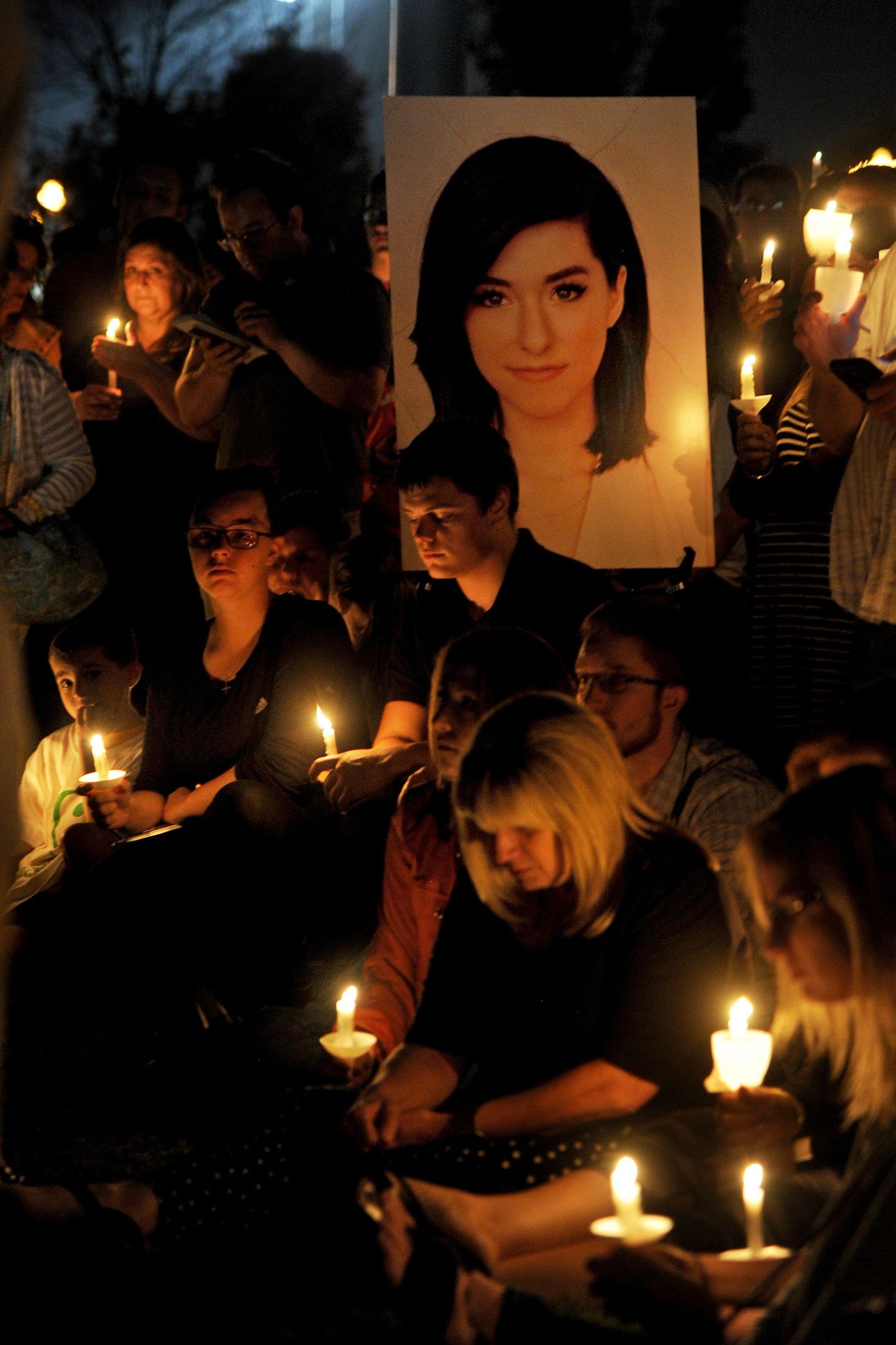 A photo of Christina Grimmie, 22, is displayed as participants hold a vigil to honor the singer killed Friday night in Orlando, Fla., on Monday, June 13, 2016, in Evesham Township, N.J. Hundreds of people have gathered at the candlelight vigil in the New Jersey hometown of the singer who was gunned down after a Florida concert. Grimmie was killed Friday night as she signed autographs after a show in Orlando. (Tom Gralish/The Philadelphia Inquirer via AP)  PHIX OUT; TV OUT; MAGS OUT; NEWARK OUT; MANDATORY CREDIT