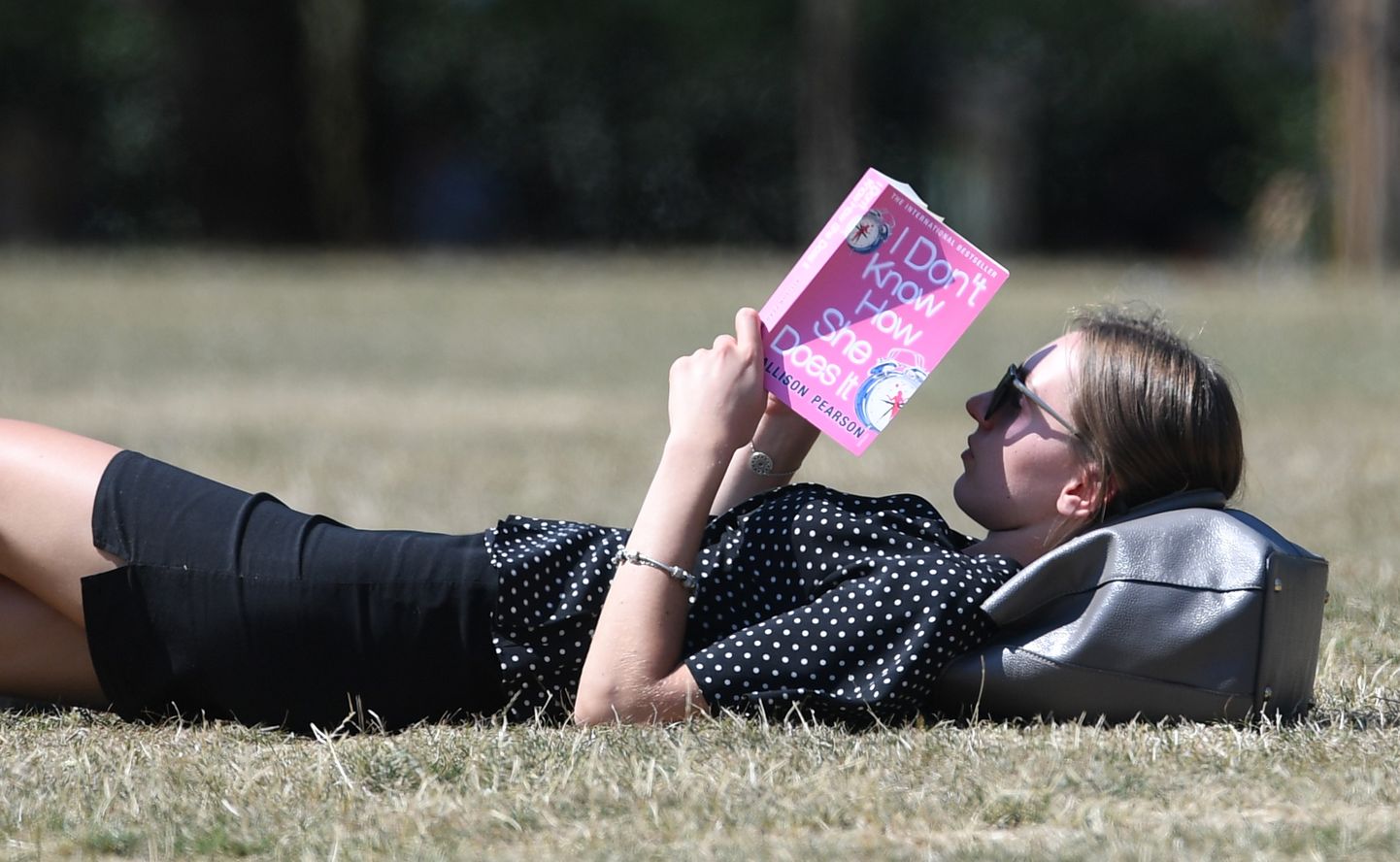 A woman reads a book in Green Park in London, Britain, 03 August 2018. Health warnings have been issued this week after forecasters predicted a second heatwave this weekend, with temperatures predicted to reach 31 centigrades in London.  EPA/FACUNDO ARRIZABALAGA
