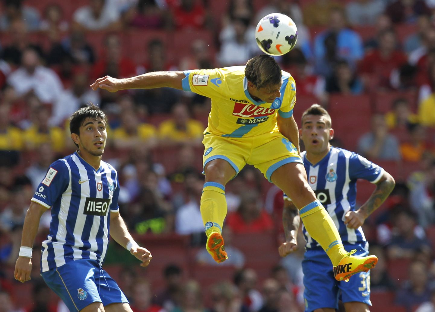 Napoli's Italian striker Emanuele Calaio heads the ball during the pre-season friendly football match between Napoli and FC Porto at The Emirates Stadium in north London on August 4, 2013, the game is one of four matches played over two days for the Emirates Cup. AFP PHOTO/IAN KINGTON
