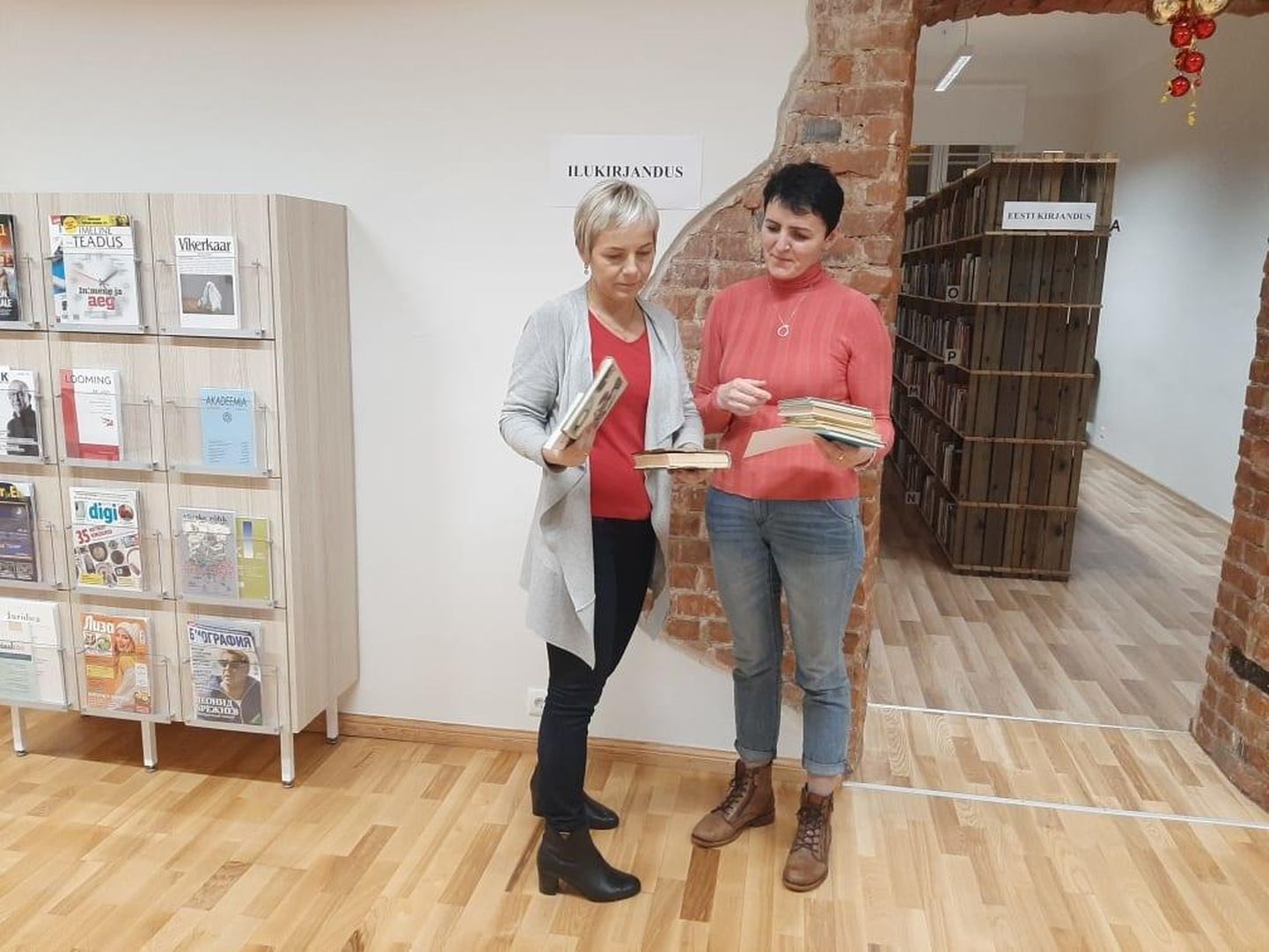 Türi raamatukogu direktor Astrid Karpender (vasakul) annab Türi põhikooli õpetajale Aili Avile üle raamatud, mida head inimesed on koolile annetuseks toonud.