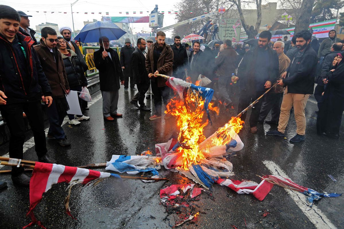 Islamirevolutsiooni aastapäeva tähistavad inimesed põletamas Teheranis USA lippe.