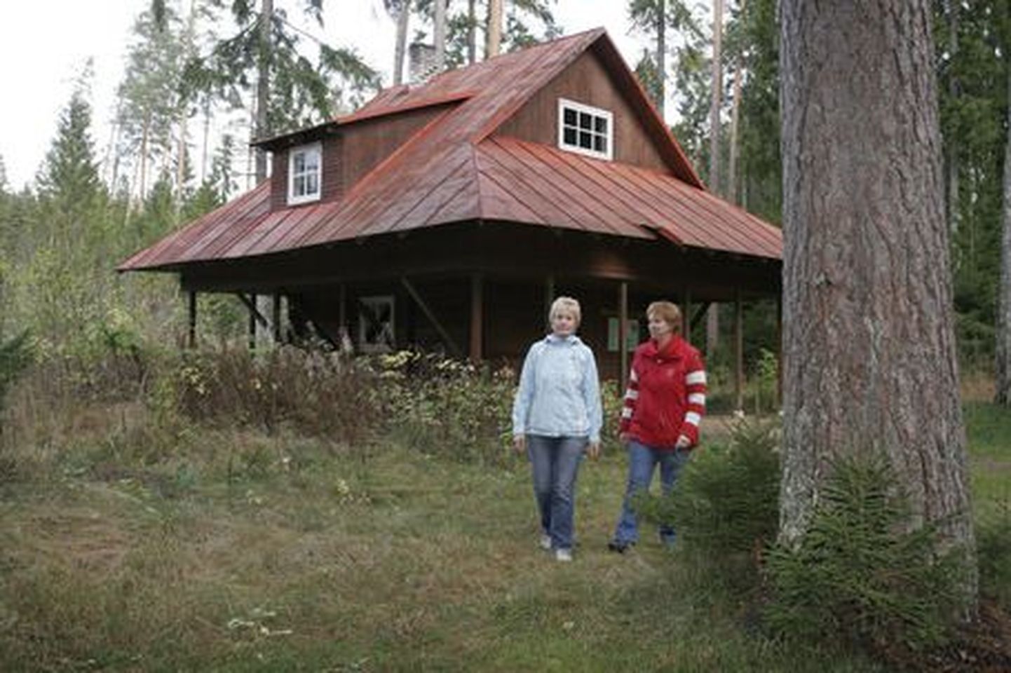 Vanapagana metsamaja perenaine Heli Ilmet (vasakul) ja RMK Sakala puhkeala juhataja Ly Laanemets metsamaja ees.