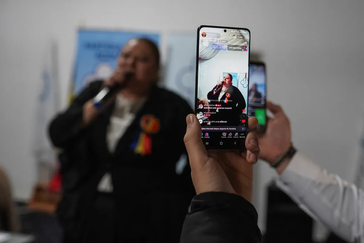 Diana Sosoaca, leader of the SOS party, is live streamed on TikTok as she talks to her supporters at her book launching, two days before the parliamentary elections, in Bucharest, Romania, November 29, 2024.