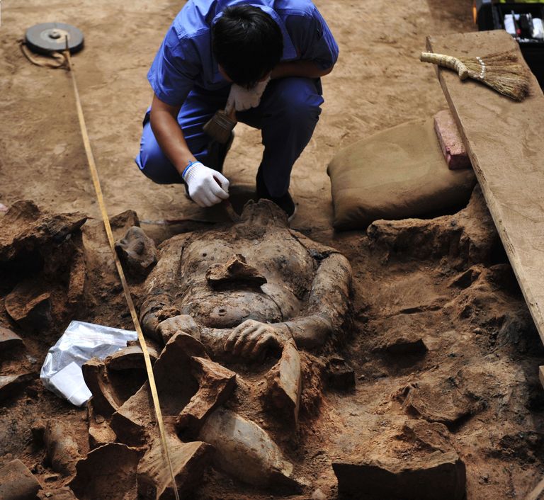 Arheoloogiameeskonna liige kaevamas välja ja puhastamas terrakotasõdalast