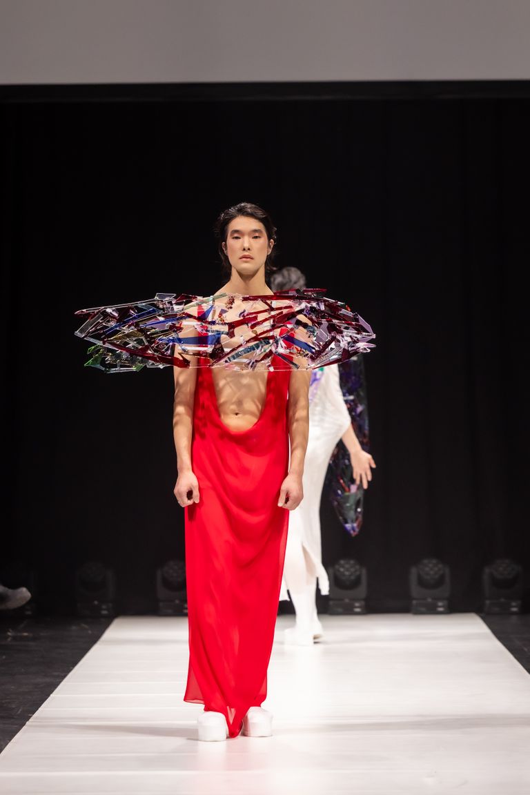 Karl Joonas Alamaa fantaasiakollektsioon, punast kleiti ja tiibu kannab imekaunis meesmodell.