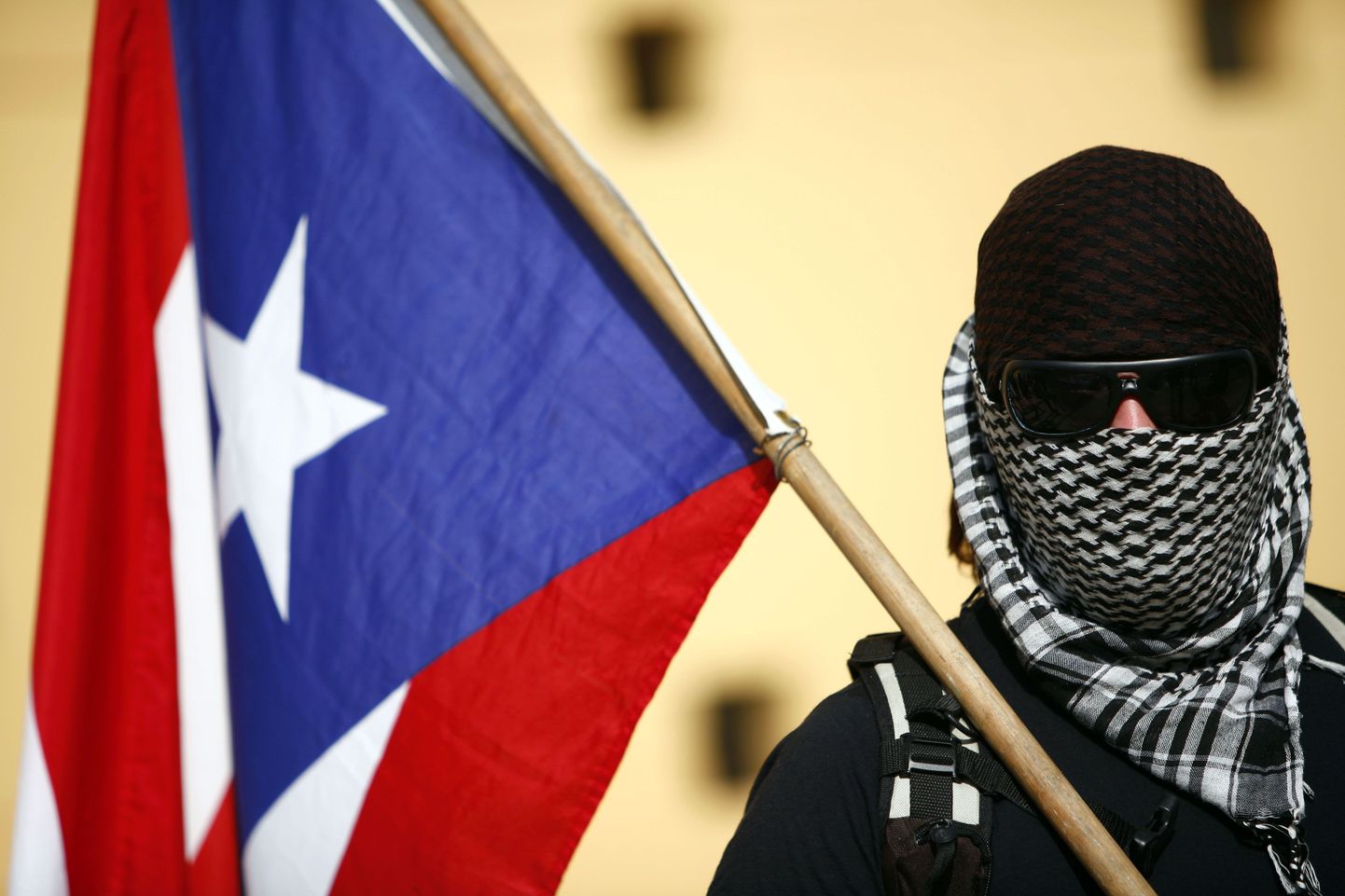 Puerto Rico lippu kandev maskiga mees