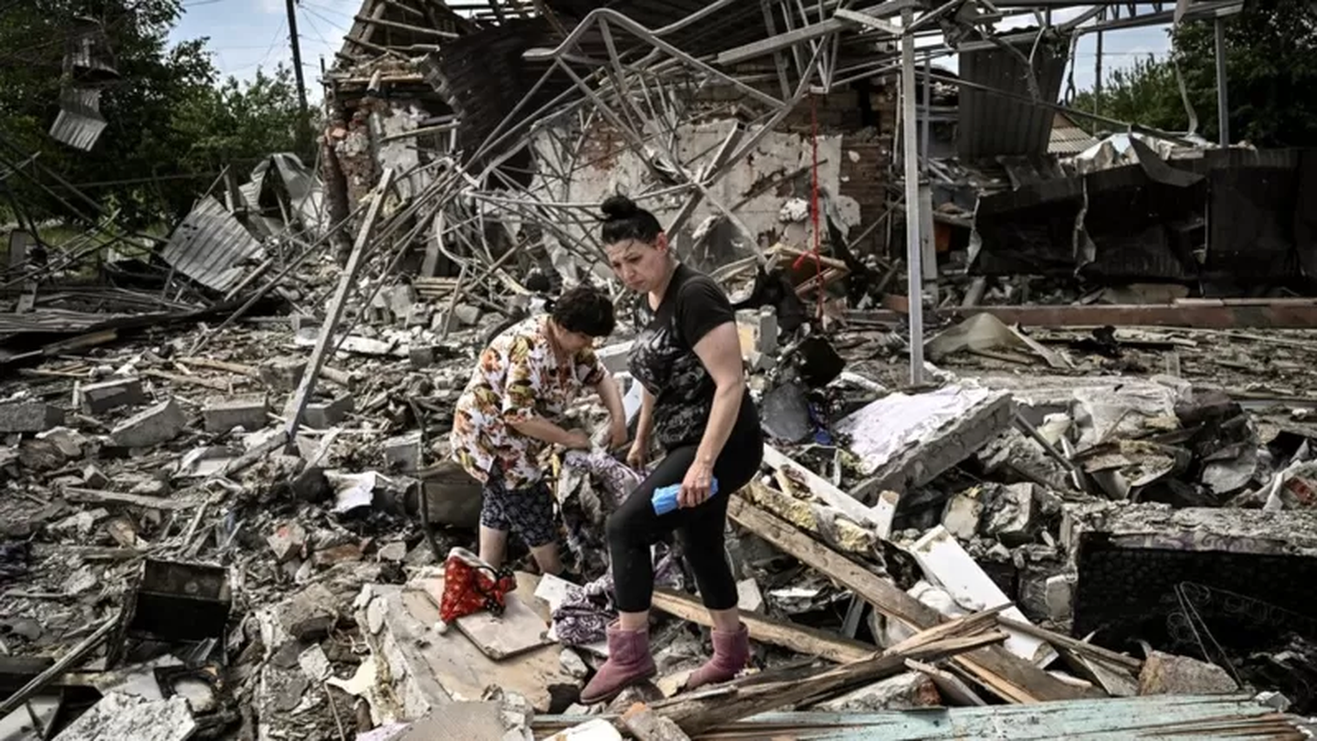 Жители Донбасса собирают пожитки на руинах дома, разрушенного в результате российского обстрела, 1 июня 2022 года