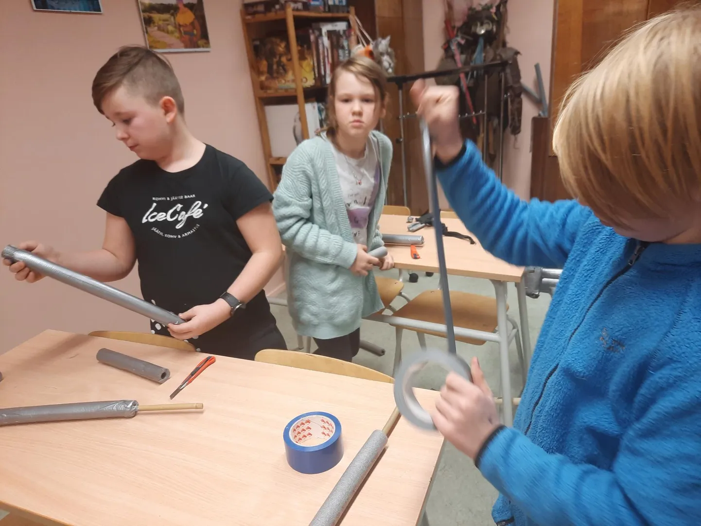 Tarvastu gümnaasiumi lapsed valmistasid endale pehmikmõõku. Et mõõk koos püsiks, on see vaja teibiga kokku liimida.