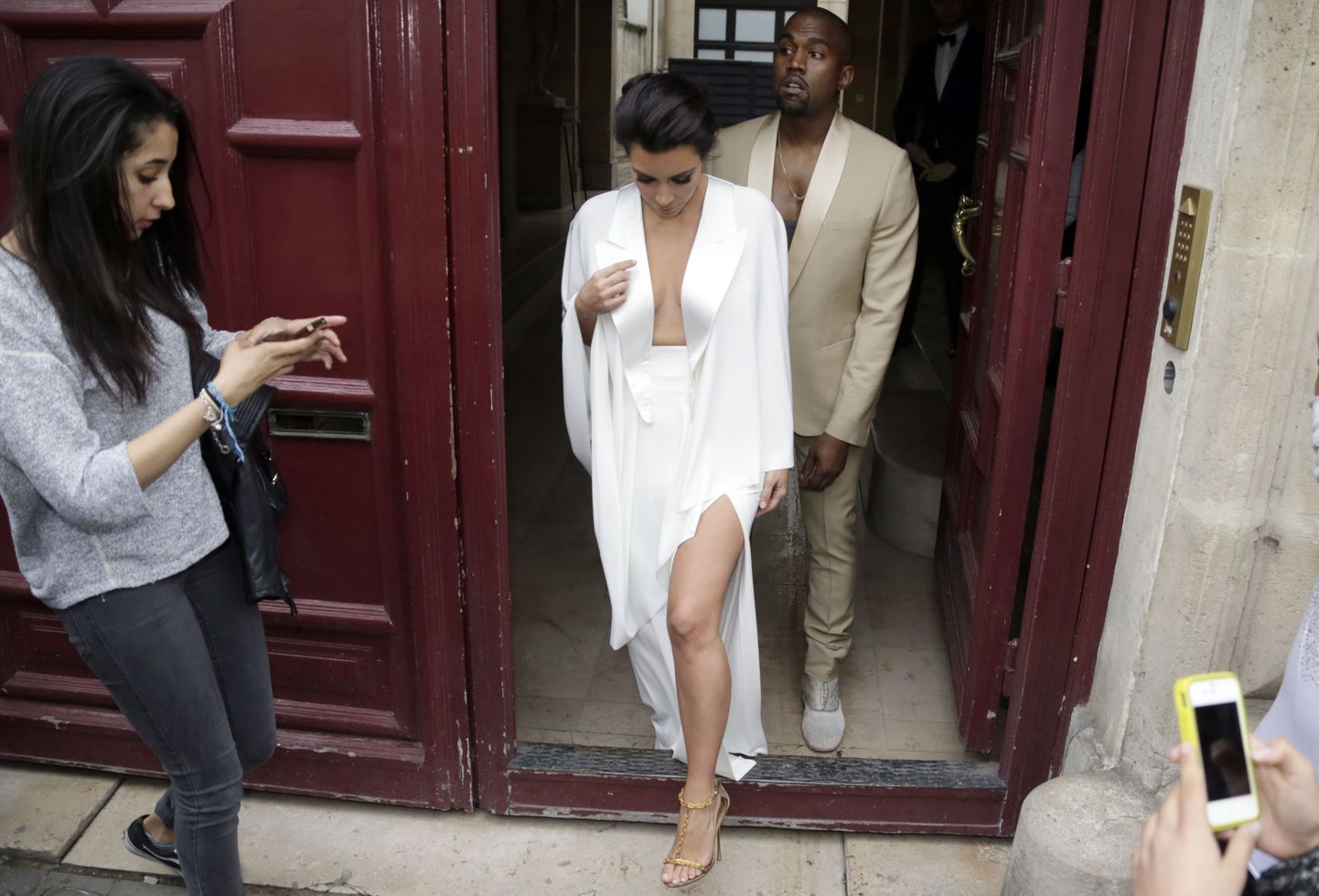 TOPSHOTS
American reality TV star Kim Kardashian (L) and American singer Kanye West (R) leave their residence in Paris on May 23, 2014, ahead of their wedding. Kanye West and his bride-to-be Kim Kardashian lunched on May 23 at a French chateau owned by iconic designer Valentino, kicking off a marathon celebration expected to culminate in the wedding of the year. AFP PHOTO / KENZO TRIBOUILLARD