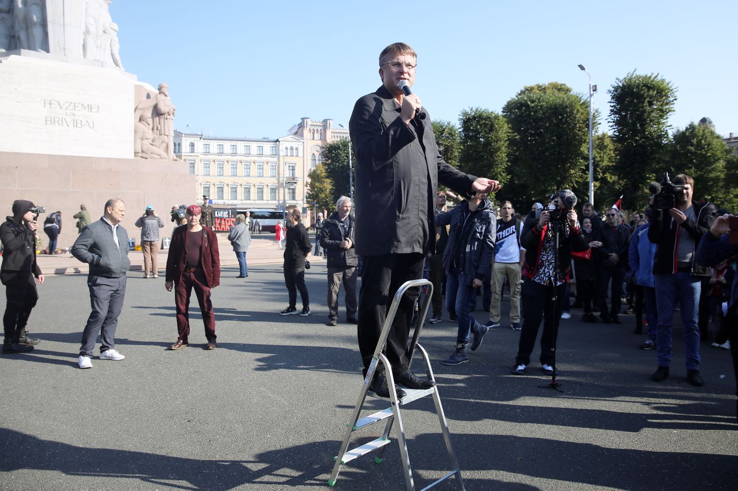 Partijas "Latvija pirmajā vietā" līderis Ainārs Šlesers uzrunā klātesošos partijas organizētajā protesta akcijā par brīvprātīgu vakcināciju pie Brīvības pieminekļa.