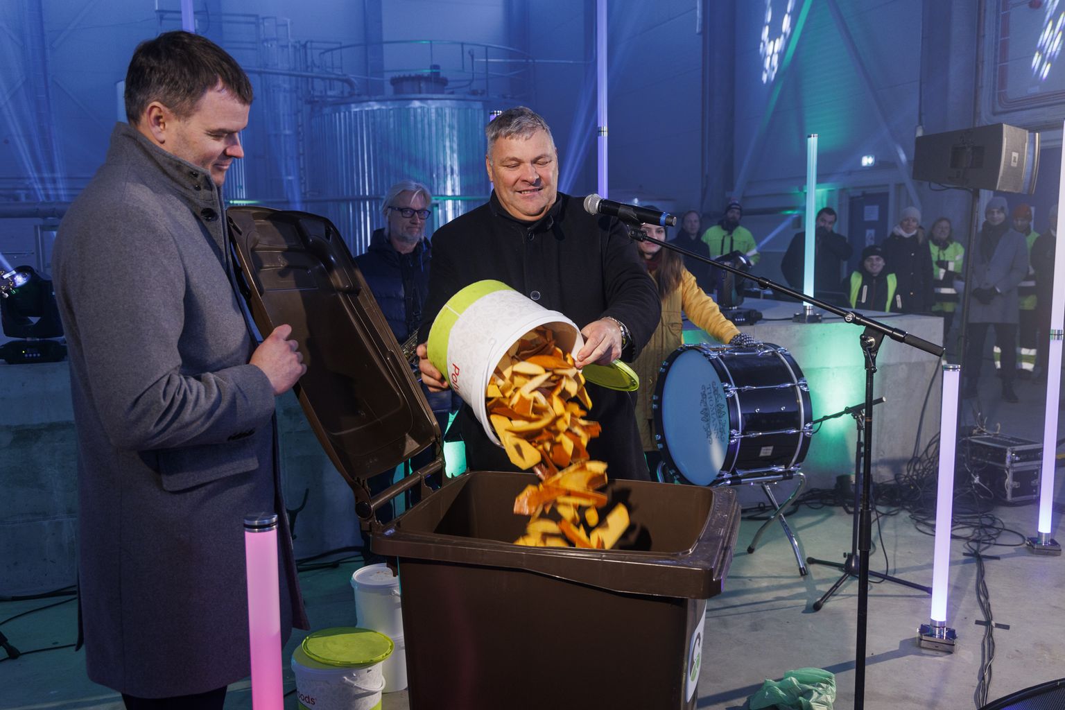 Endine keskkonnaminister Marko Pomerants tühjendab praeguse keskkonnaminister Madis Kallase valvsa pilgu alla prügikasti ämbritäie toidujäätmeid.