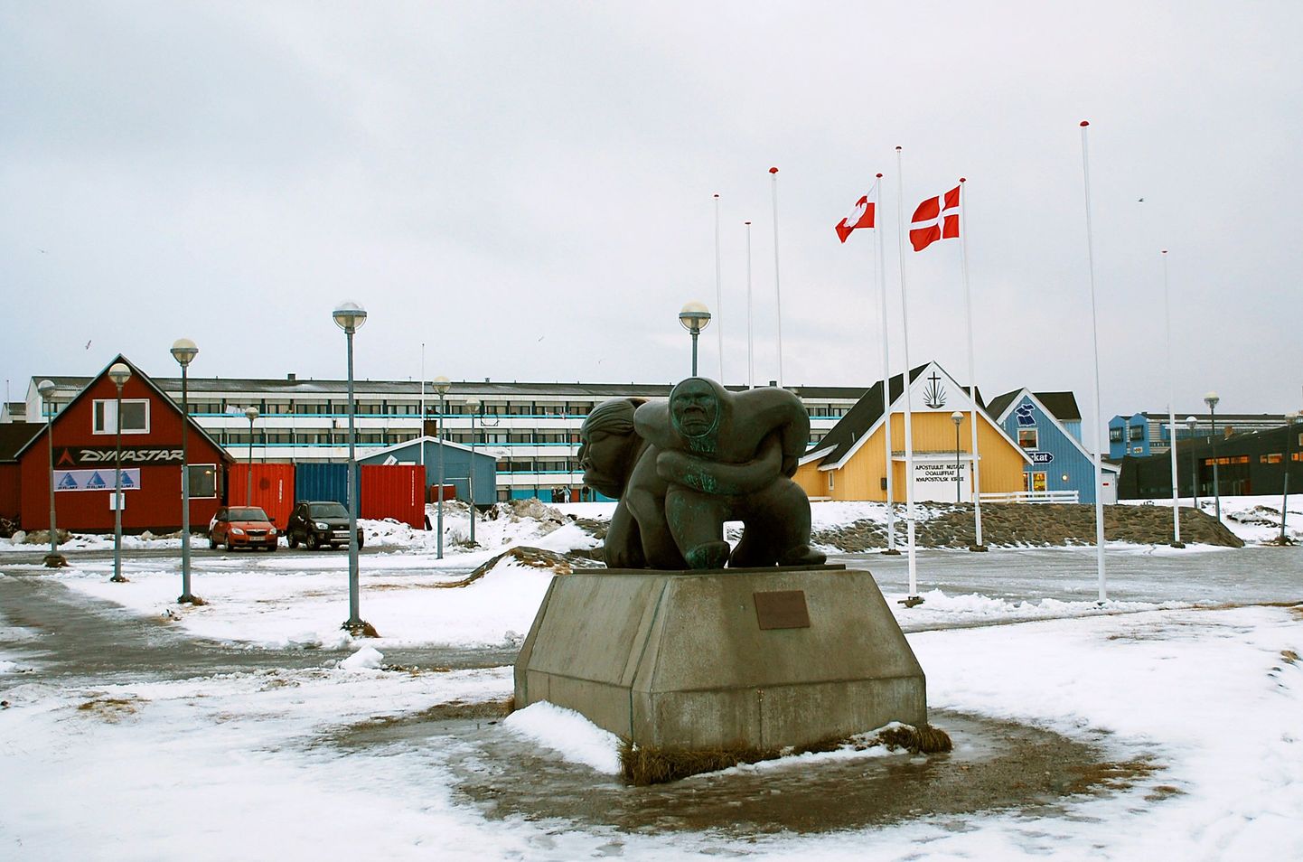 TO GO WITH AFP STORY BY SLIM ALLAGIU --- The Greenland (L) and Danish flags flutter behind a sculpture, called Kaassassuk which symbolises an Inuit legend about an orphan child being hunted, but protected by a female spirit, (depicted on the left), who gives him strength and confidence in himself, in downtown Nuuk, the capital of Greenland, on November 24, 2008, the eve of a referendum on self-determination. Most of the around 39,000 eligible voters on this Arctic island share the same view, with a recent poll indicating that as many as 75 percent of Greenlanders intend to vote "aap," or "yes" to the proposal to give the semi-autonomous Danish territory self-rule.  With the referendum, the Arctic island, which was granted semi-autonomy from Denmark in 1979, has the chance to take over control of new areas such as natural resource management, justice and police affairs and to a certain extent foreign affairs AFP PHOTO/Slim Allagui